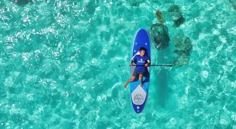 Guest enjoying a paddle boat activity in the lagoon Seaweed Village